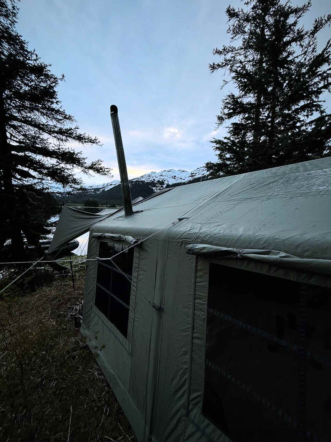 K1 Outdoors tent at dusk with mountains in the background