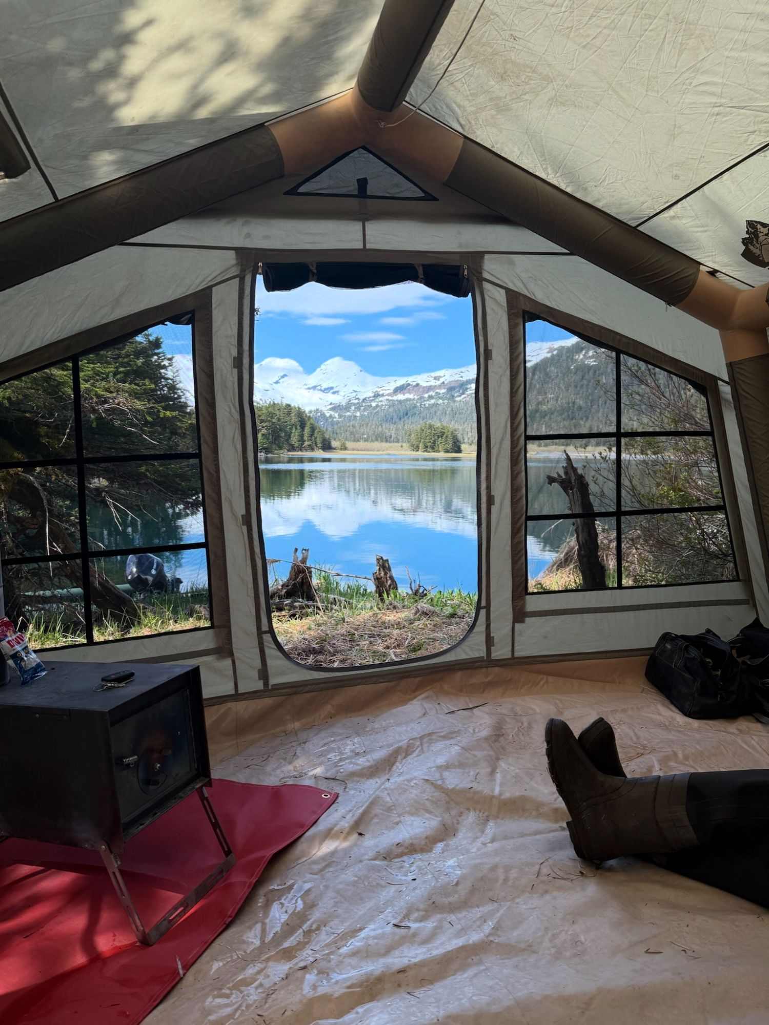 Family-friendly glamping tent interior with a lake view